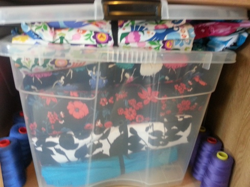 Some of my fabric goodies, stashed away in a bin. I tie all my fabric into rolls, it makes it 1000 times easier to dig through and tip them out and pet them. 
